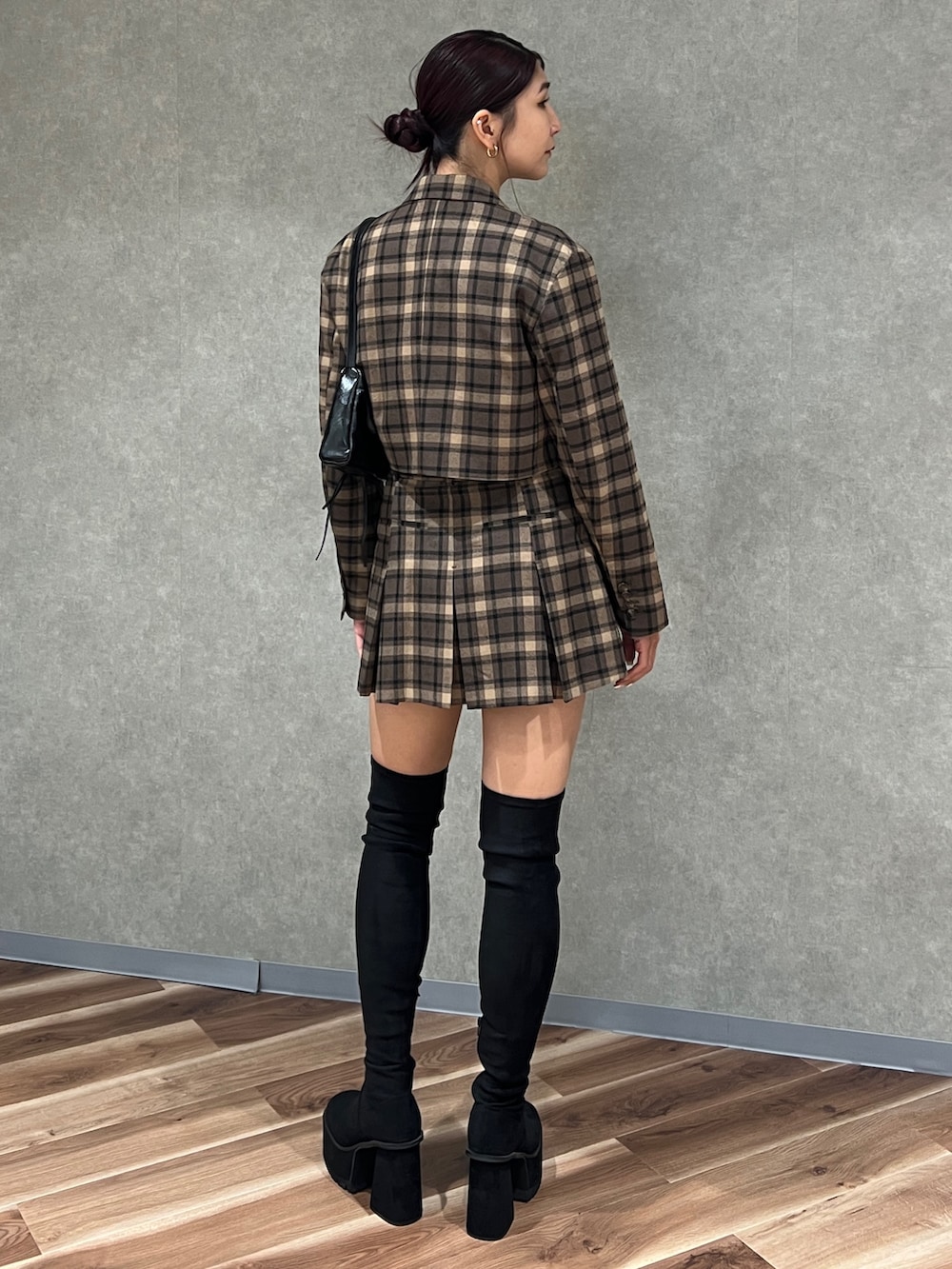 その他のテーラードジャケット、ブラック系のブーツ、ホワイト系のニット/セーターを着用したレディースの秋コーディネートの3枚目の写真