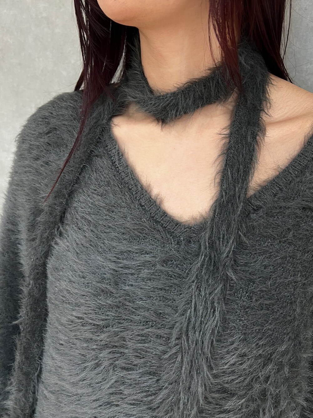 グレー系のワンピース、ブラック系のショルダーバッグ、ブラック系のブーツを着用したレディースの秋コーディネートの8枚目の写真