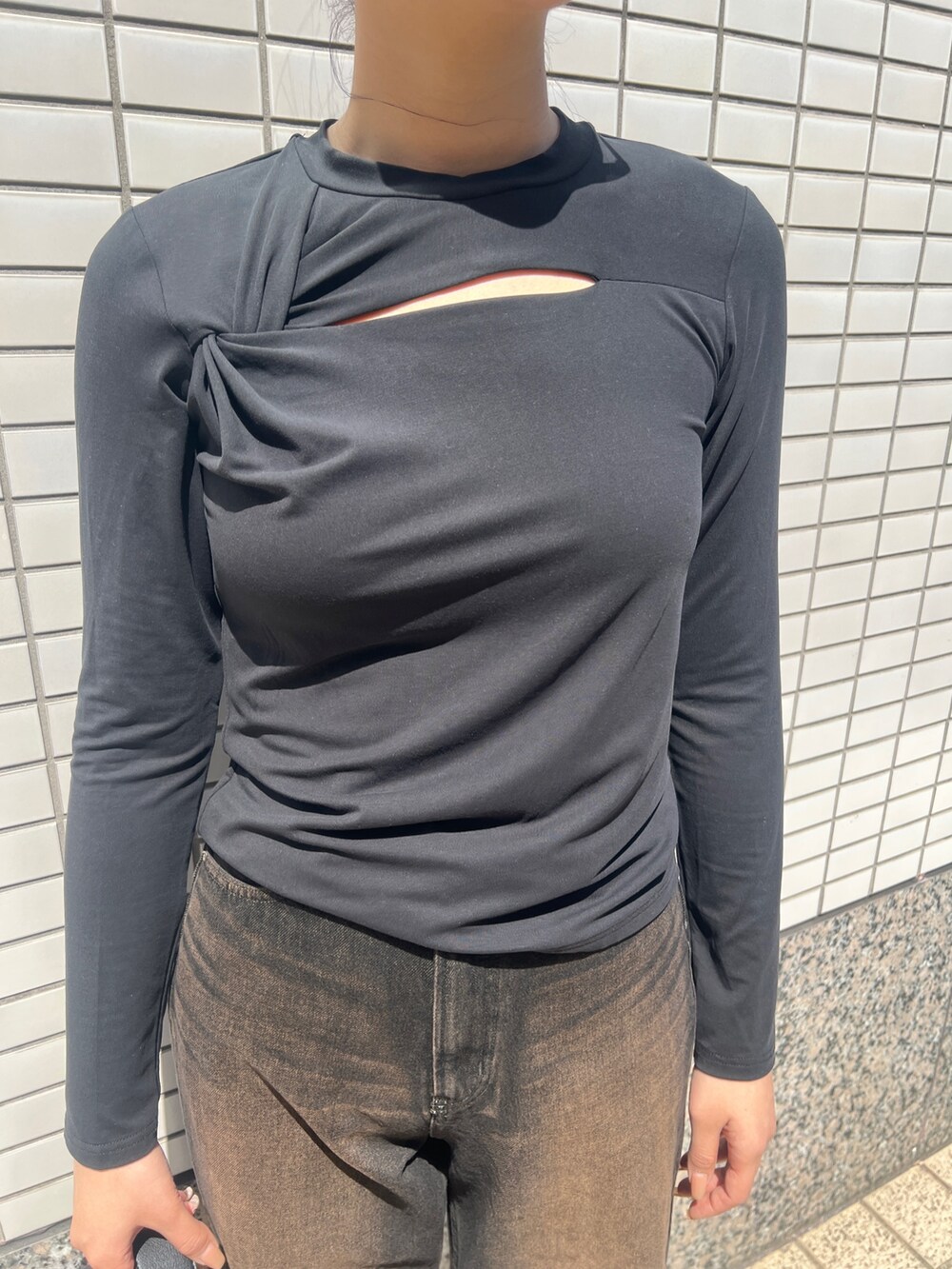 ブラック系のデニムパンツ、ブラック系のブーツ、ブラック系のTシャツ/カットソーを着用したレディースの春コーディネートの4枚目の写真