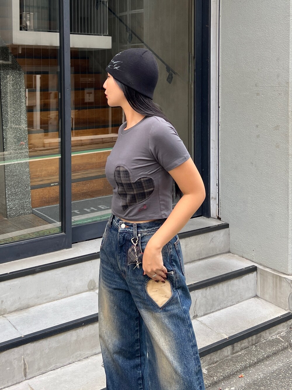 グレー系のTシャツ/カットソー、ブルー系のデニムパンツ、ブラック系のスニーカーを着用したレディースの夏コーディネートの3枚目の写真