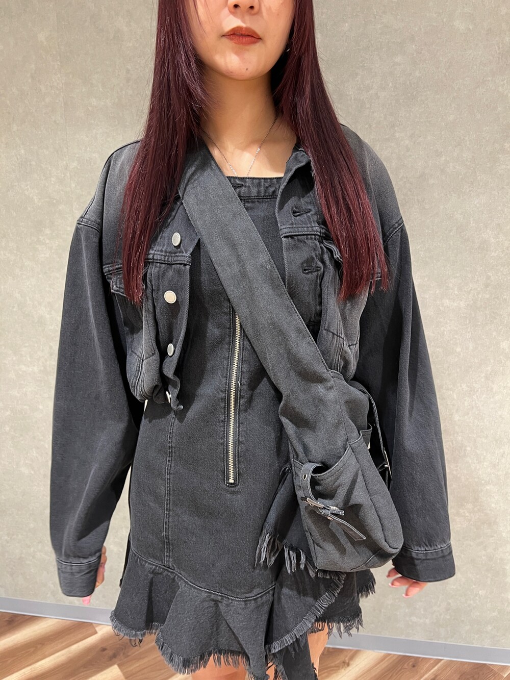 ブラック系のワンピース、ブラック系のデニムジャケット、ブラウン系のブーツを着用したレディースの冬コーディネートの5枚目の写真