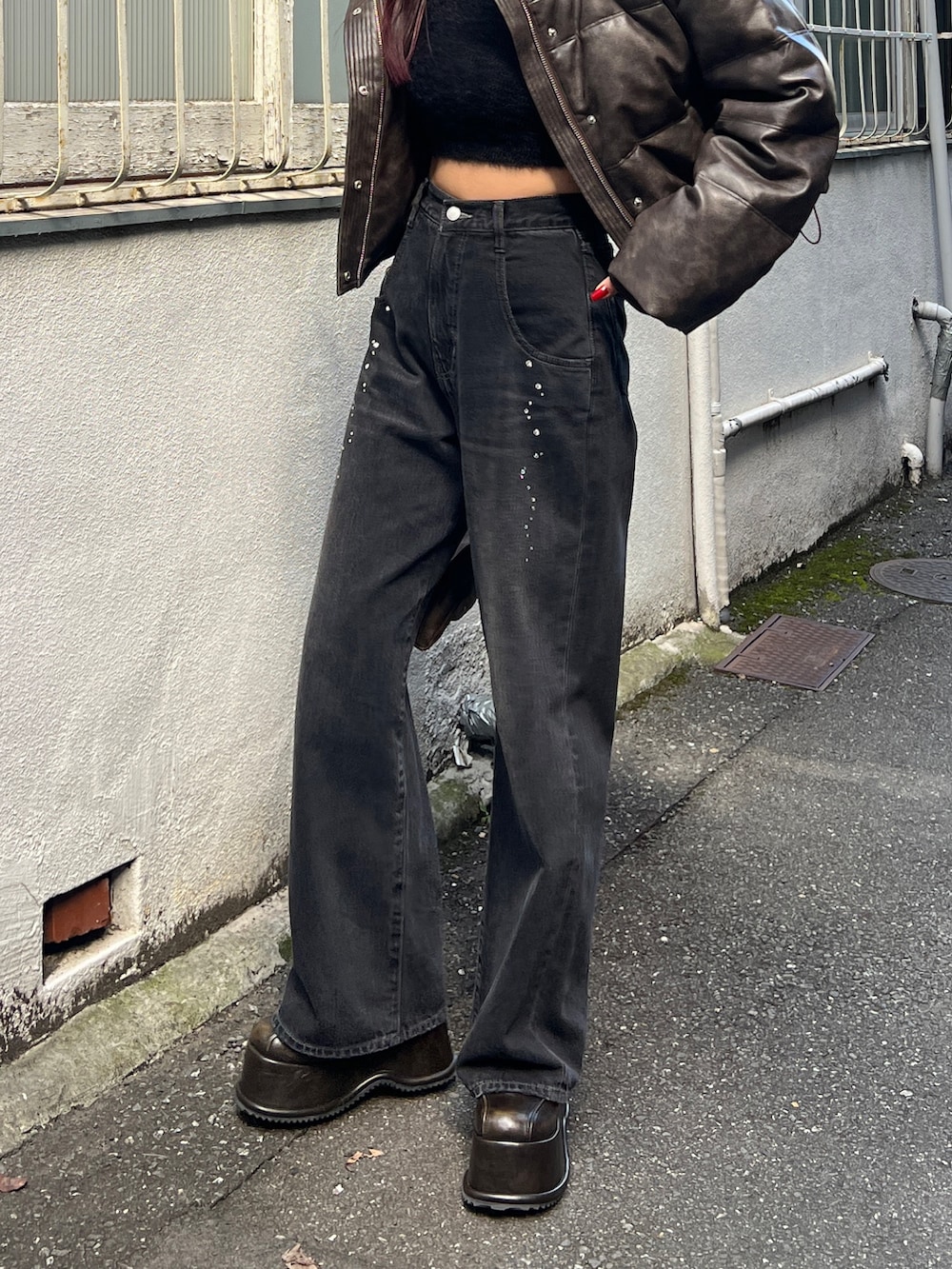 ブラウン系のダウンジャケット/コート、ブラック系のニット/セーター、ブラック系のデニムパンツを着用したレディースの秋コーディネートの5枚目の写真