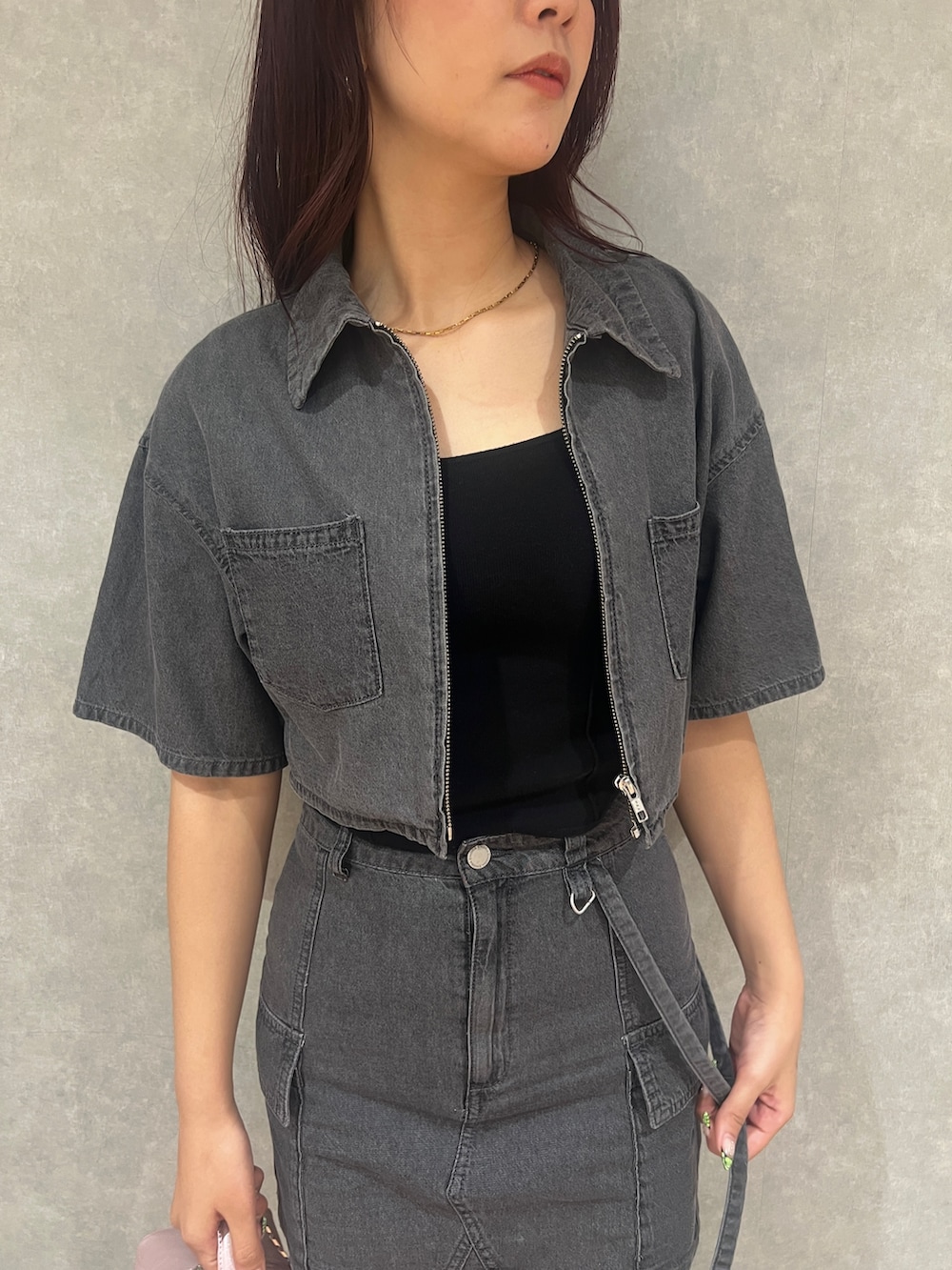 グレー系のシャツ/ブラウス、グレー系のデニムスカート、ブラック系のサンダルを着用したレディースの夏コーディネートの4枚目の写真