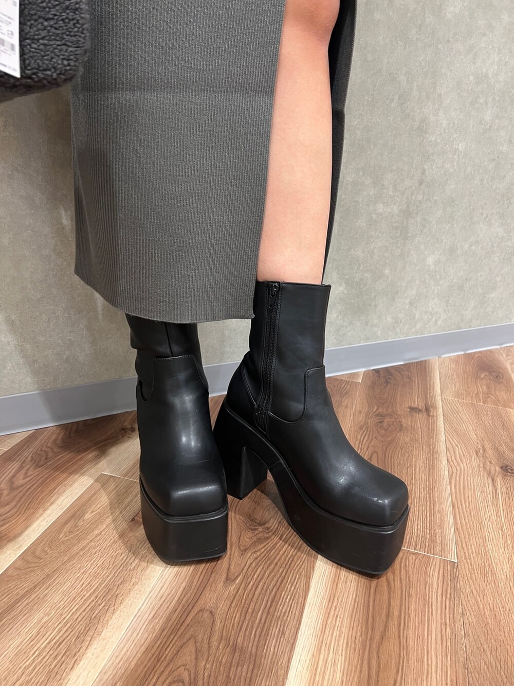 ブラック系のムートンコート、グレー系のワンピース、グレー系のハンドバッグを着用したレディースの秋コーディネートの6枚目の写真