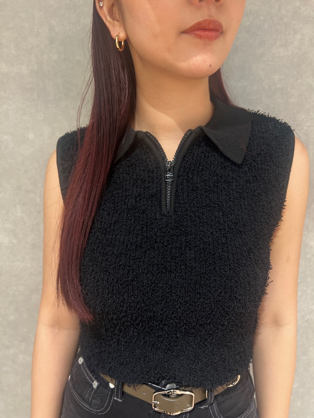 ブラック系のタンクトップ、ブラック系のデニムパンツ、ホワイト系のサンダルを着用したレディースの夏コーディネートの7枚目の写真