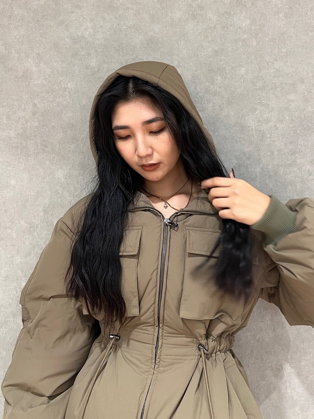 グリーン系のブルゾン、ブルー系のデニムパンツ、ブラック系のブーツを着用したレディースの秋コーディネートの7枚目の写真