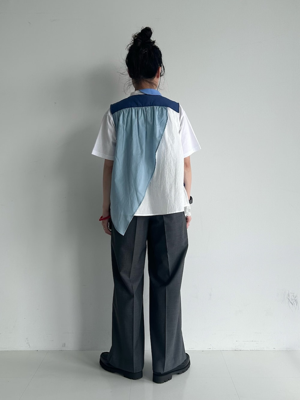 グレー系のスラックス、ブラック系のローファー、ホワイト系のTシャツ/カットソーを着用したレディースの春コーディネートの2枚目の写真