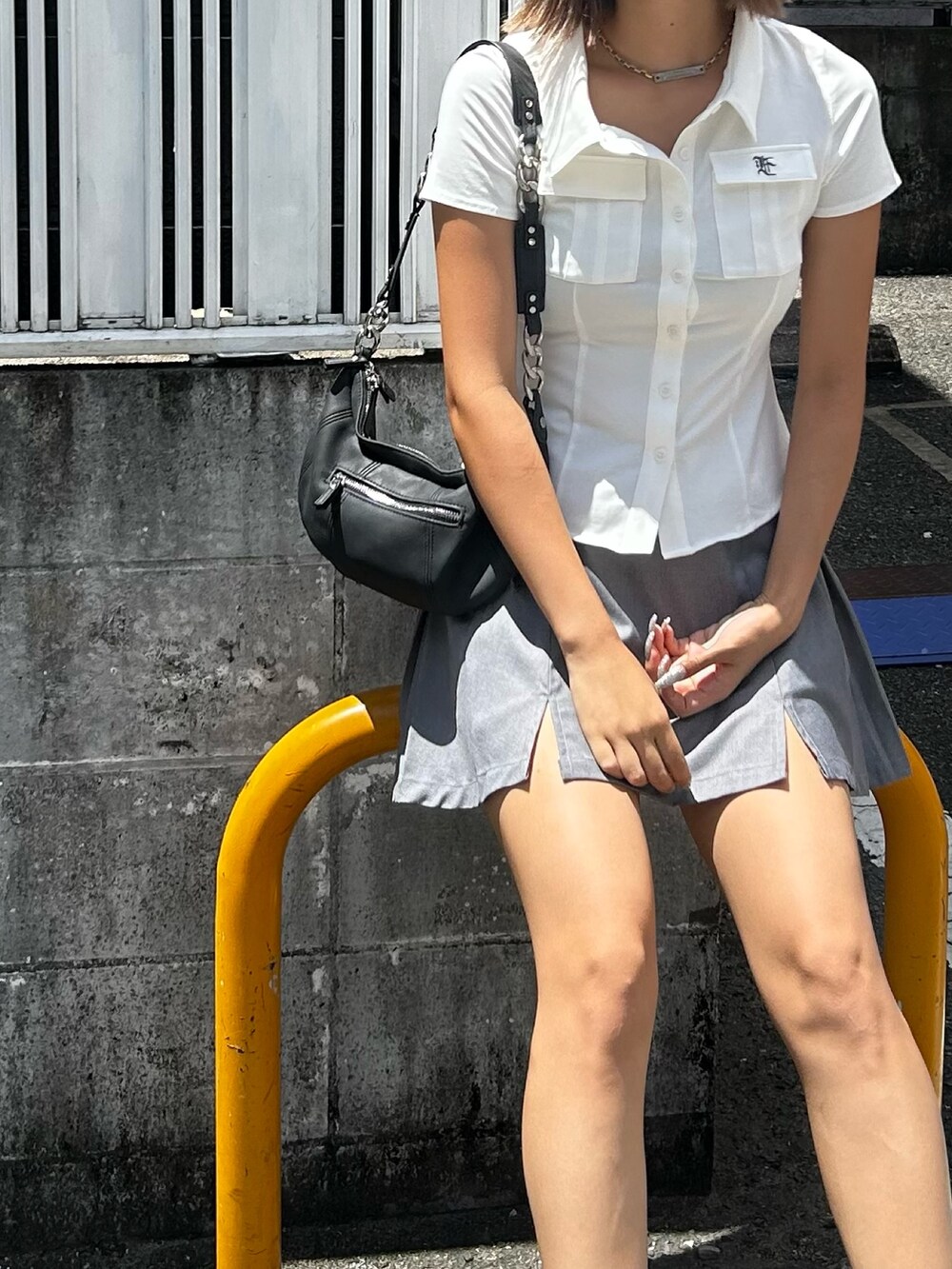 グレー系のスカート、ホワイト系のシャツ/ブラウス、ホワイト系のソックス/靴下を着用したレディースの夏コーディネートの3枚目の写真