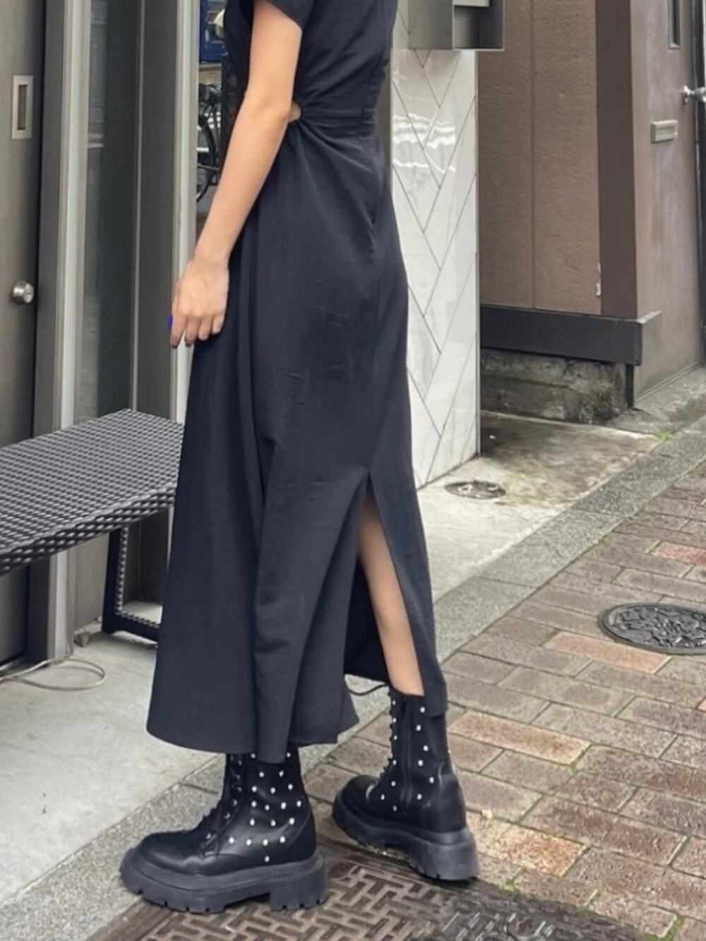 ブラック系のワンピース、ブラック系のブーツ、ブラック系のショルダーバッグを着用したレディースの夏コーディネートの2枚目の写真