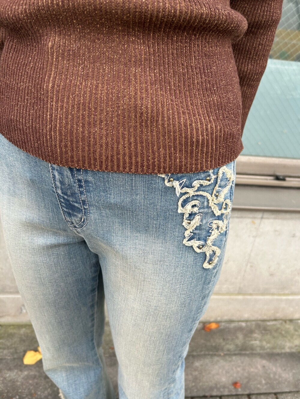 ブラウン系のニット/セーター、ベージュ系のスリッポン、ブルー系のデニムパンツを着用したレディースの秋コーディネートの8枚目の写真