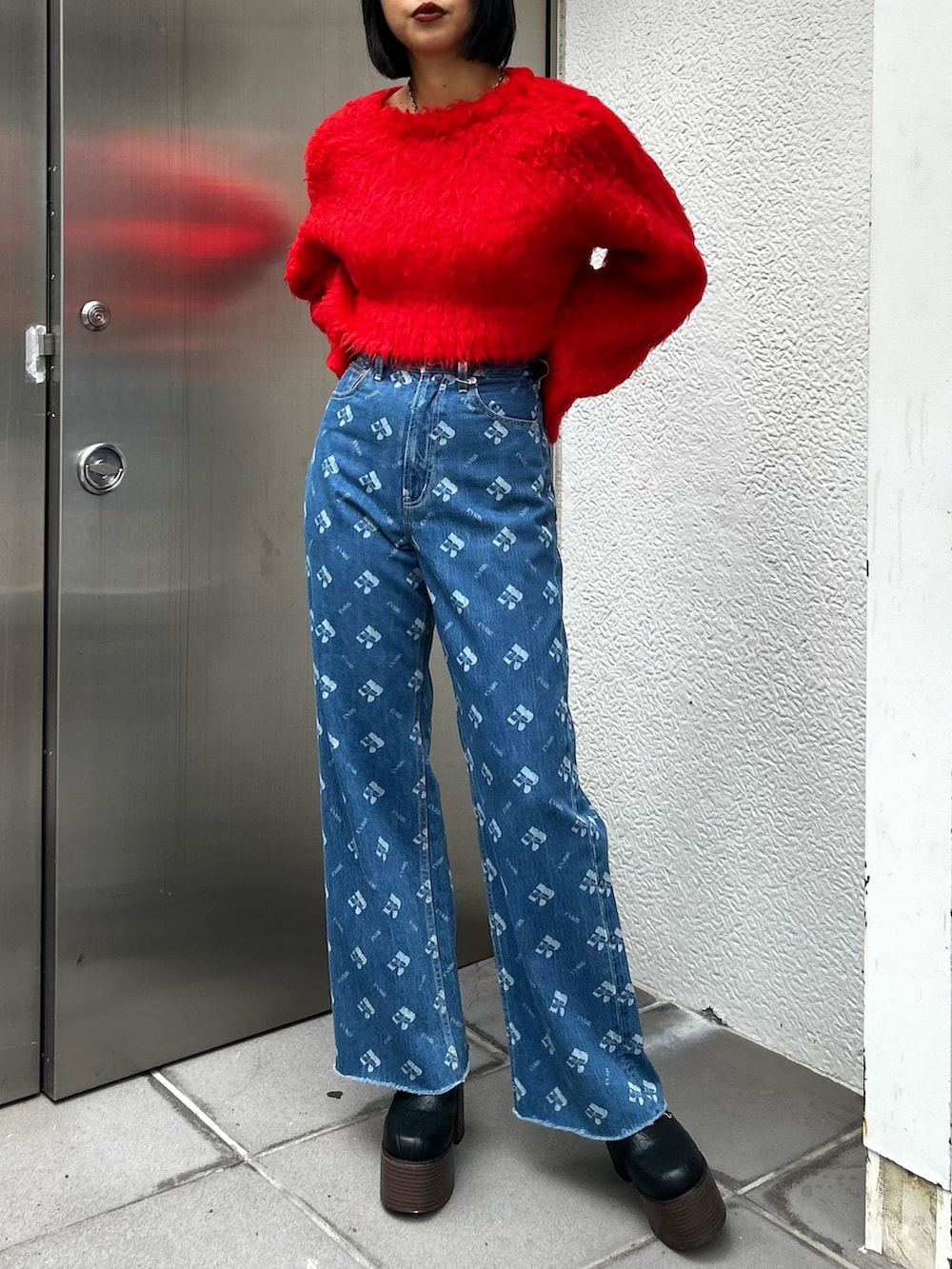 ブルー系のデニムパンツ、ホワイト系のブルゾン、レッド系のニット/セーターを着用したレディースの冬コーディネートの3枚目の写真