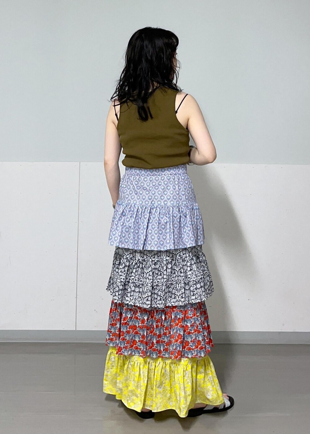 ブラック系のチューブトップ、ブラック系のハンドバッグ、その他のスカートを着用したレディースの夏コーディネートの7枚目の写真