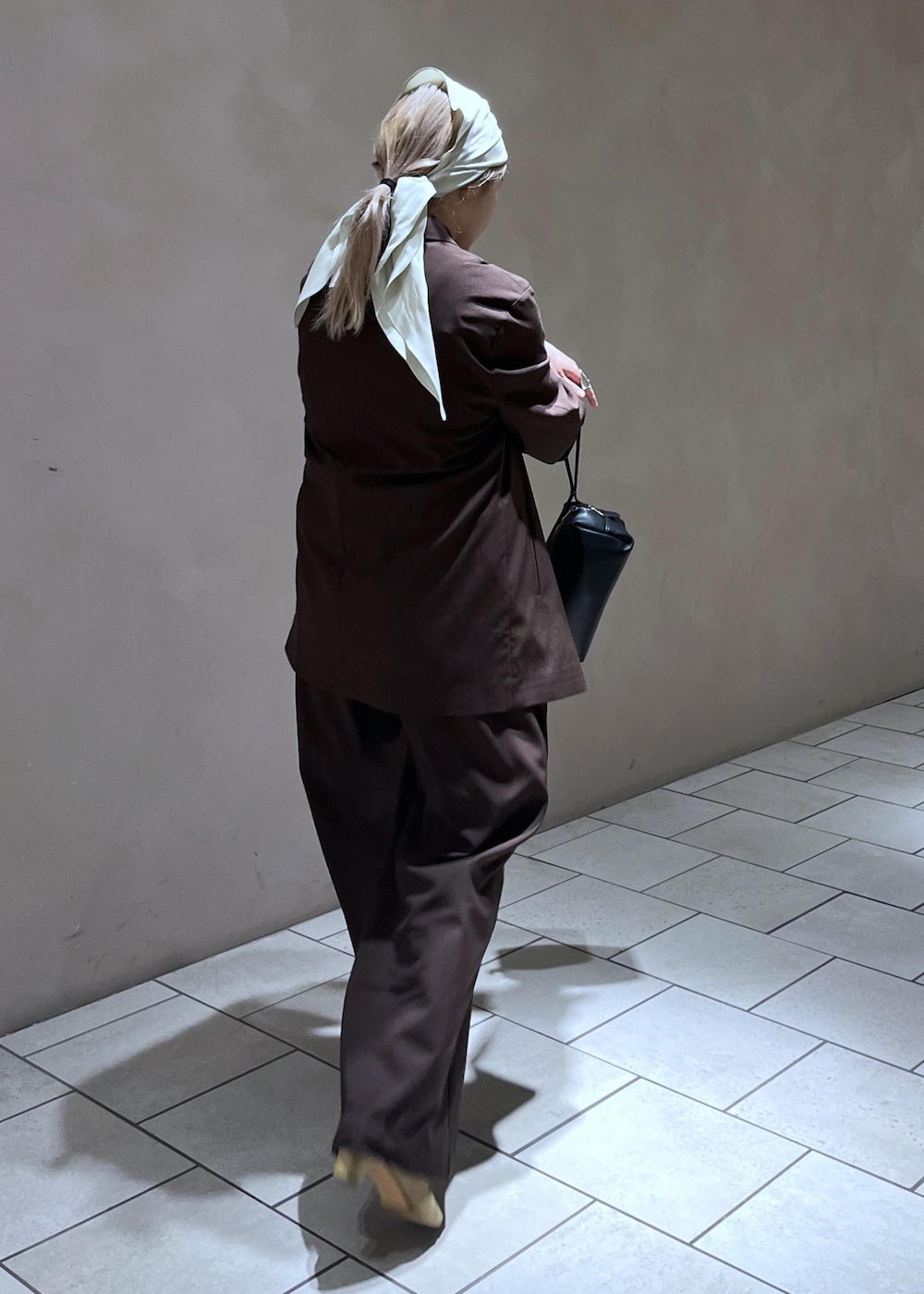 ブラック系のショルダーバッグ、ブラウン系のその他パンツ、ブラウン系のテーラードジャケットを着用したレディースの春コーディネートの2枚目の写真