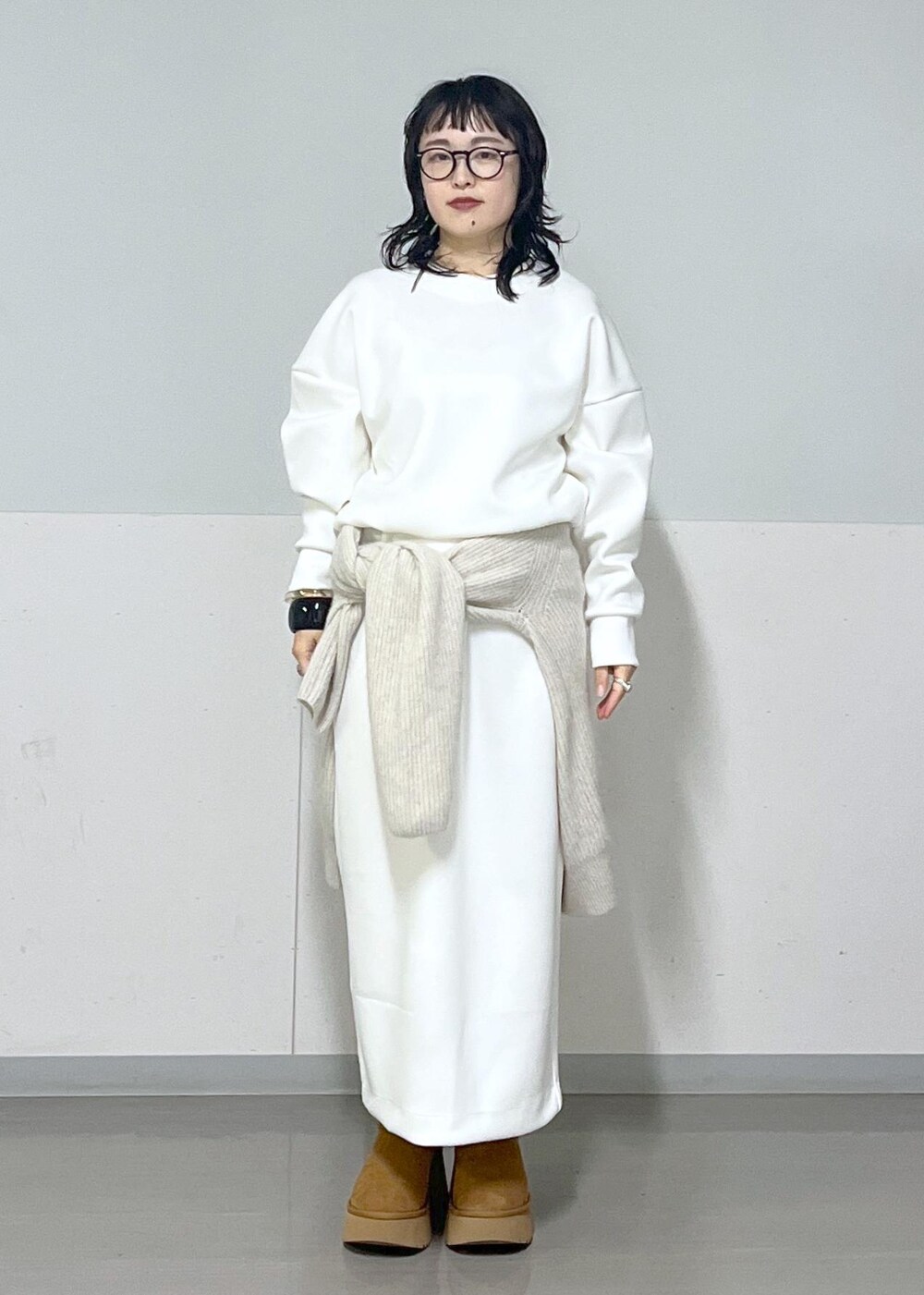 ホワイト系のカーディガン/ボレロ、ホワイト系のスカート、ホワイト系のTシャツ/カットソーを着用したレディースの冬コーディネートの4枚目の写真