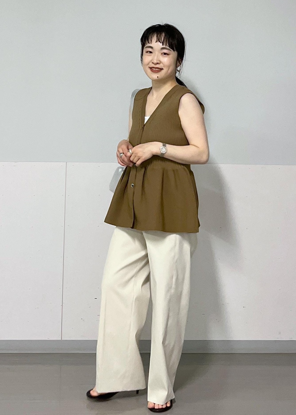 シルバー系のショルダーバッグ、ブラック系のサンダル、ホワイト系のその他パンツを着用したレディースの春コーディネートの3枚目の写真