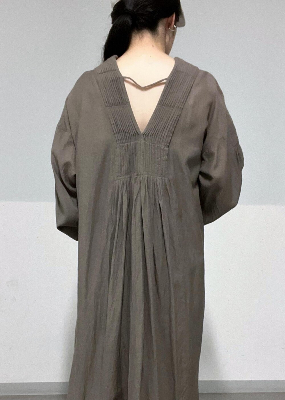 ブラウン系のサンダル、ベージュ系のショルダーバッグ、グレー系のワンピースを着用したレディースの夏コーディネートの6枚目の写真