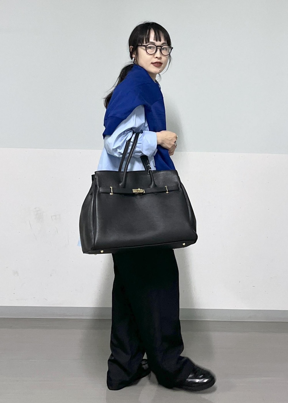 ブラック系のカーゴパンツ、ブルー系のスウェット、ブルー系のシャツ/ブラウスを着用したレディースの春コーディネートの3枚目の写真