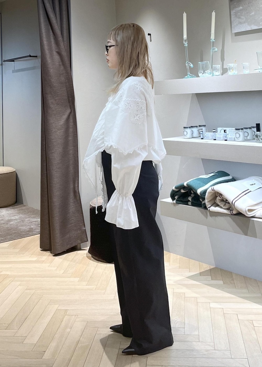 ブラック系のスラックス、ブラック系のパンプス、ホワイト系のシャツ/ブラウスを着用したレディースの冬コーディネートの3枚目の写真