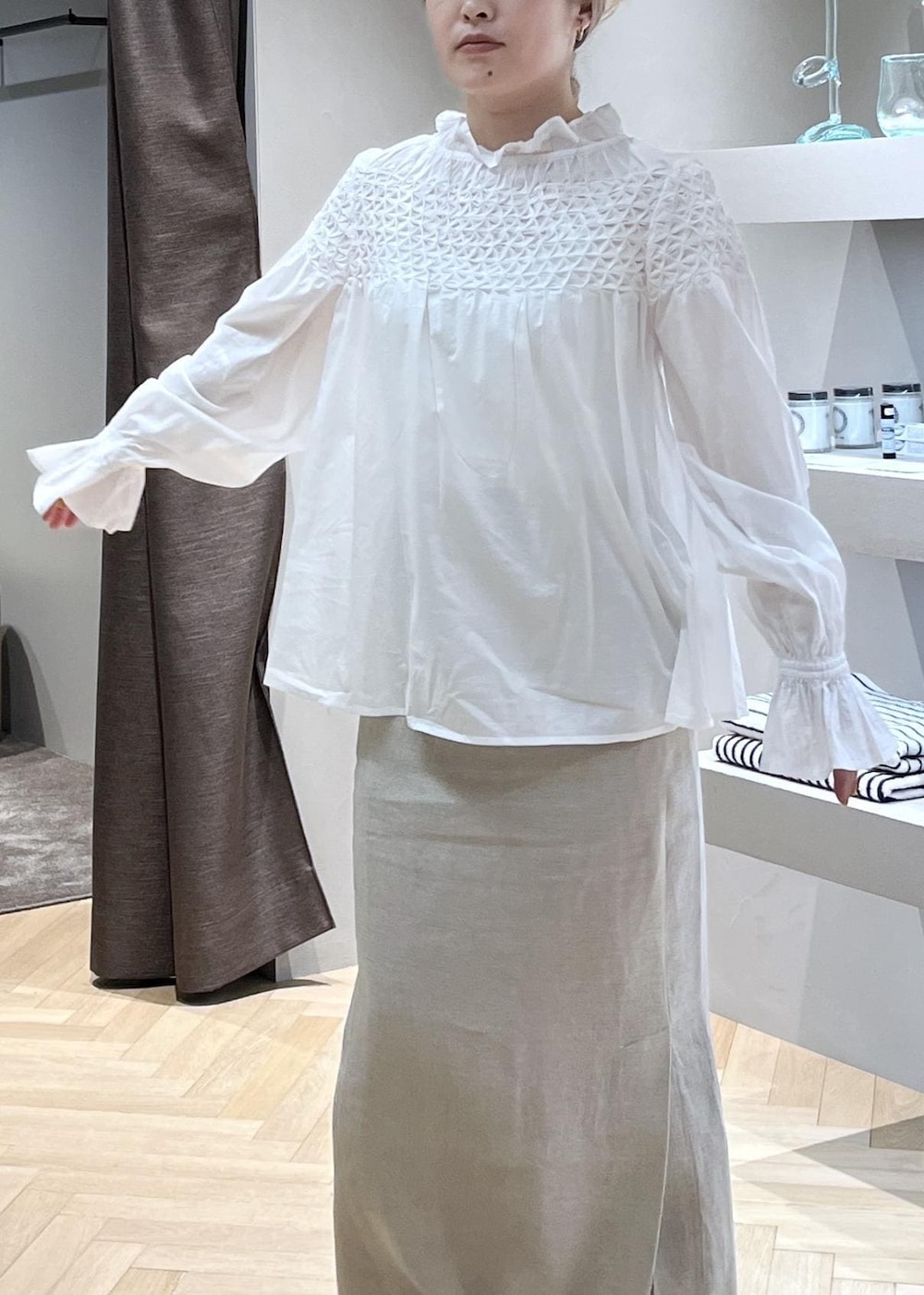 ベージュ系のスカート、ホワイト系のブルゾン、イエロー系のショルダーバッグを着用したレディースの春コーディネートの6枚目の写真