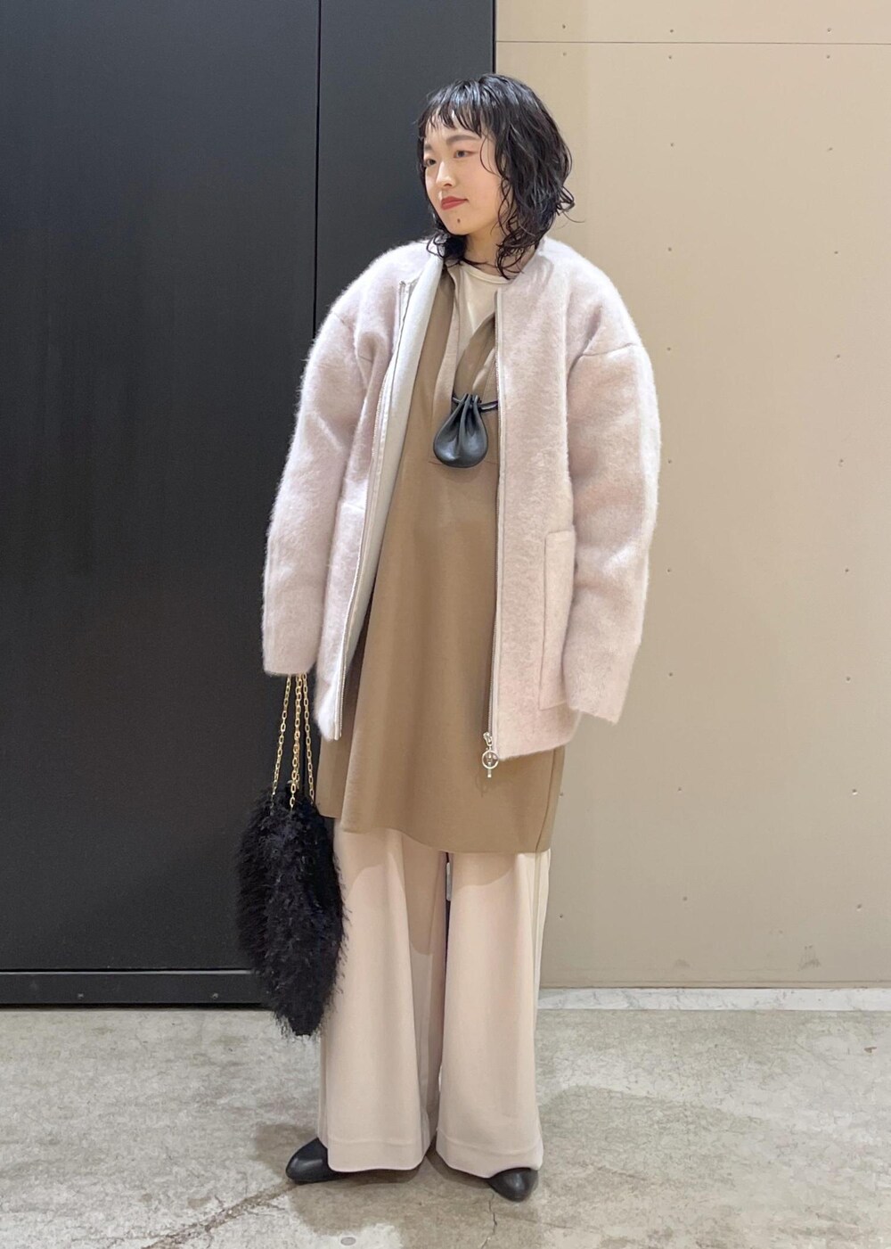 ブラック系のブーツ、イエロー系のワンピース、グレー系のブルゾンを着用したレディースの冬コーディネートの9枚目の写真