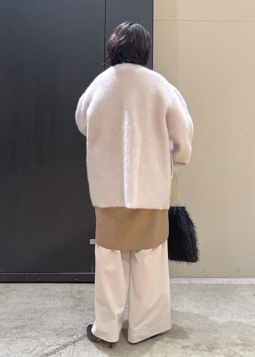 ブラック系のブーツ、イエロー系のワンピース、グレー系のブルゾンを着用したレディースの冬コーディネートの10枚目の写真