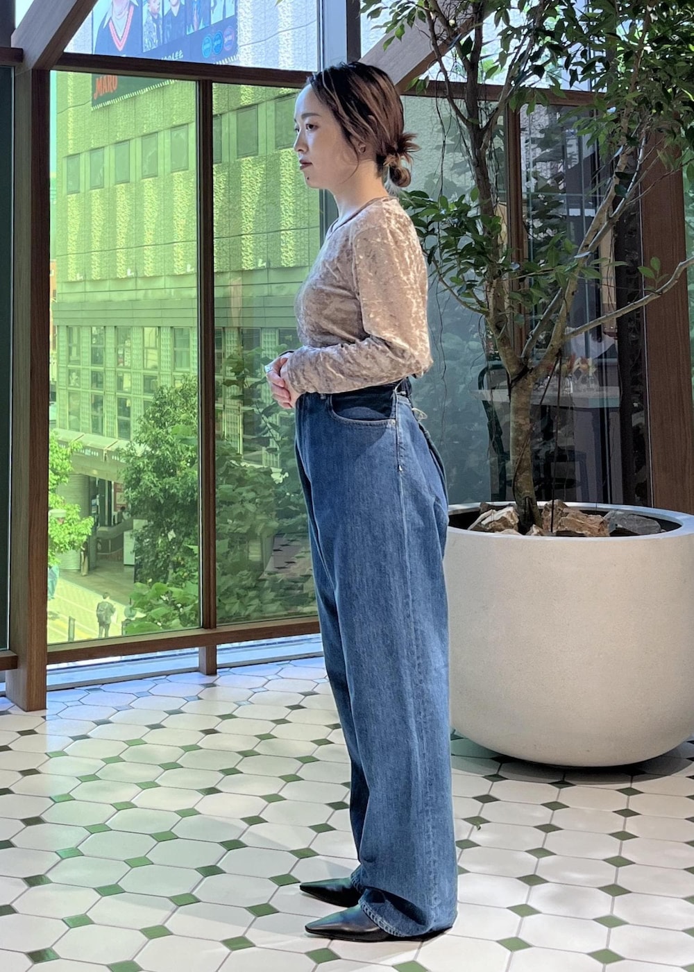 ベージュ系のショルダーバッグ、ブラック系のダウンジャケット/コート、ブルー系のデニムジャケットを着用したレディースの秋コーディネートの8枚目の写真