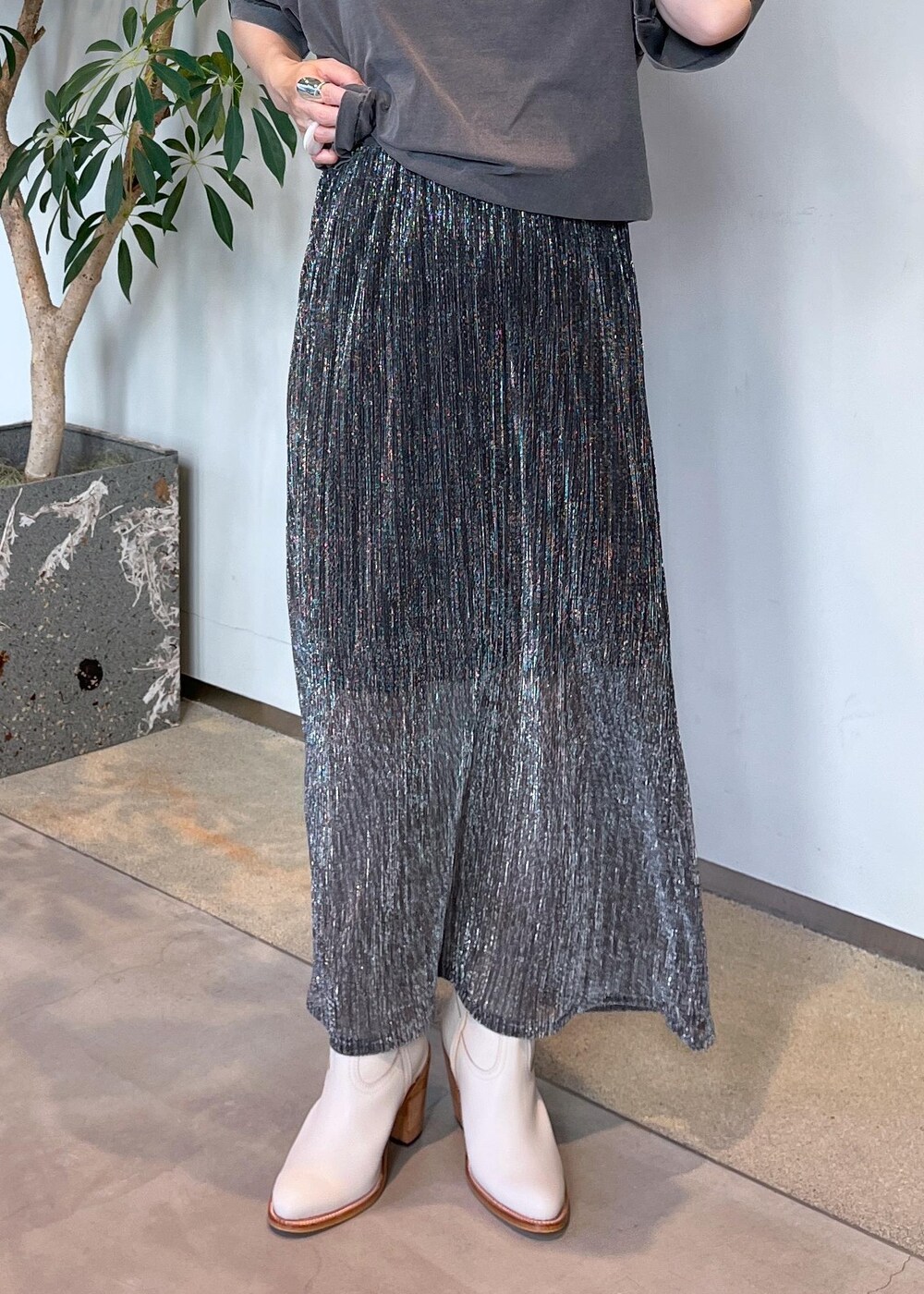 ブラウン系のショルダーバッグ、シルバー系のスカート、グレー系のTシャツ/カットソーを着用したレディースの夏コーディネートの4枚目の写真