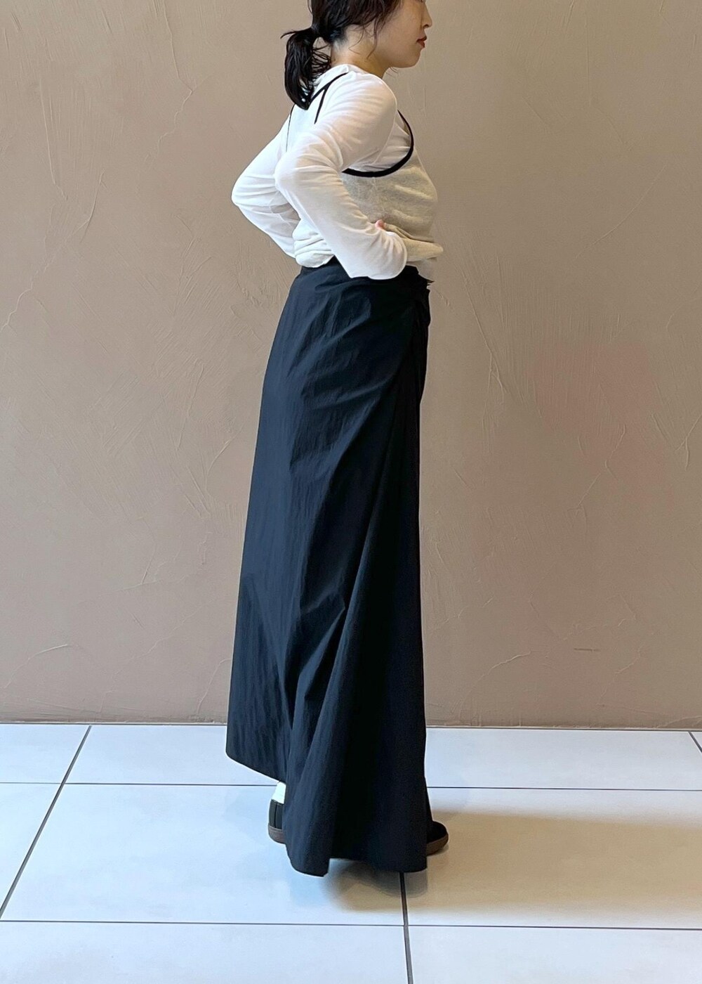 ブラック系のスカート、ベージュ系のタンクトップ、ホワイト系のTシャツ/カットソーを着用したレディースの夏コーディネートの8枚目の写真