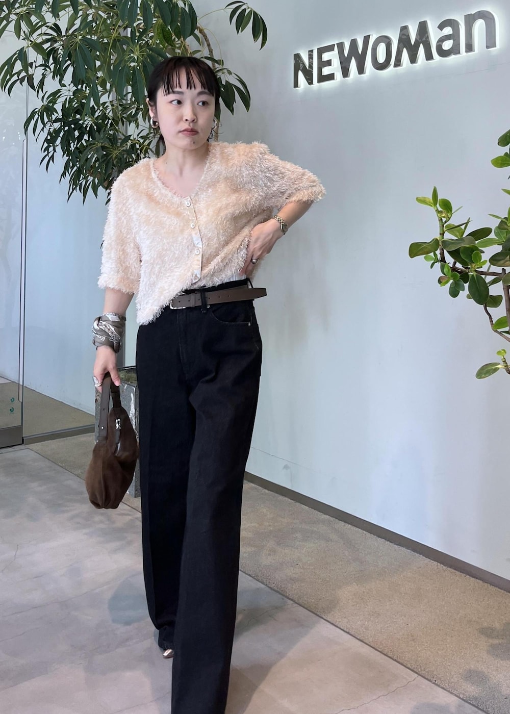 グレー系のデニムパンツ、ベージュ系のその他トップス、ブラウン系のショルダーバッグを着用したレディースの夏コーディネートの2枚目の写真