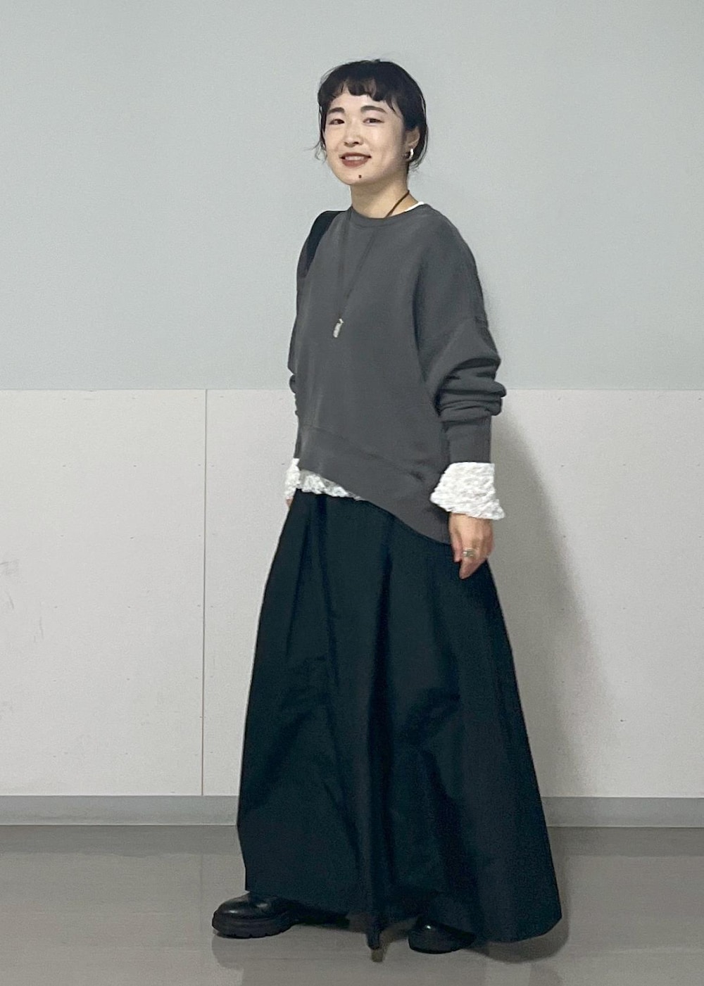 ブラック系のボディバッグ/ウエストポーチ、グレー系のスウェット、ブラック系のスカートを着用したレディースの秋コーディネートの2枚目の写真