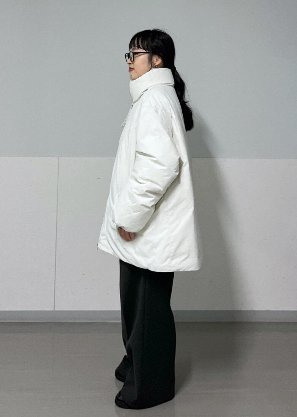 グレー系のその他パンツ、ホワイト系のダウンジャケット/コート、ホワイト系のTシャツ/カットソーを着用したレディースの秋コーディネートの6枚目の写真