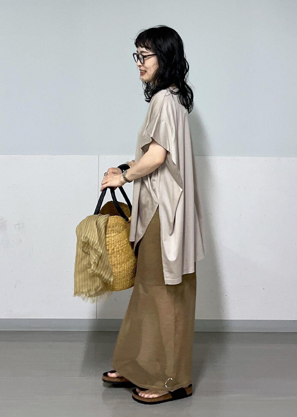 ベージュ系のTシャツ/カットソー、ゴールド系のスカート、イエロー系のバンダナ/スカーフを着用したレディースの夏コーディネートの2枚目の写真