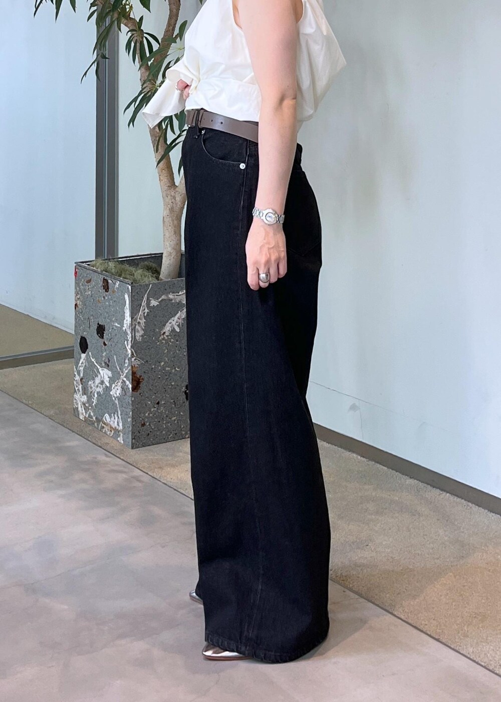 グレー系のデニムパンツ、ホワイト系のシャツ/ブラウス、ブラウン系のショルダーバッグを着用したレディースの夏コーディネートの5枚目の写真