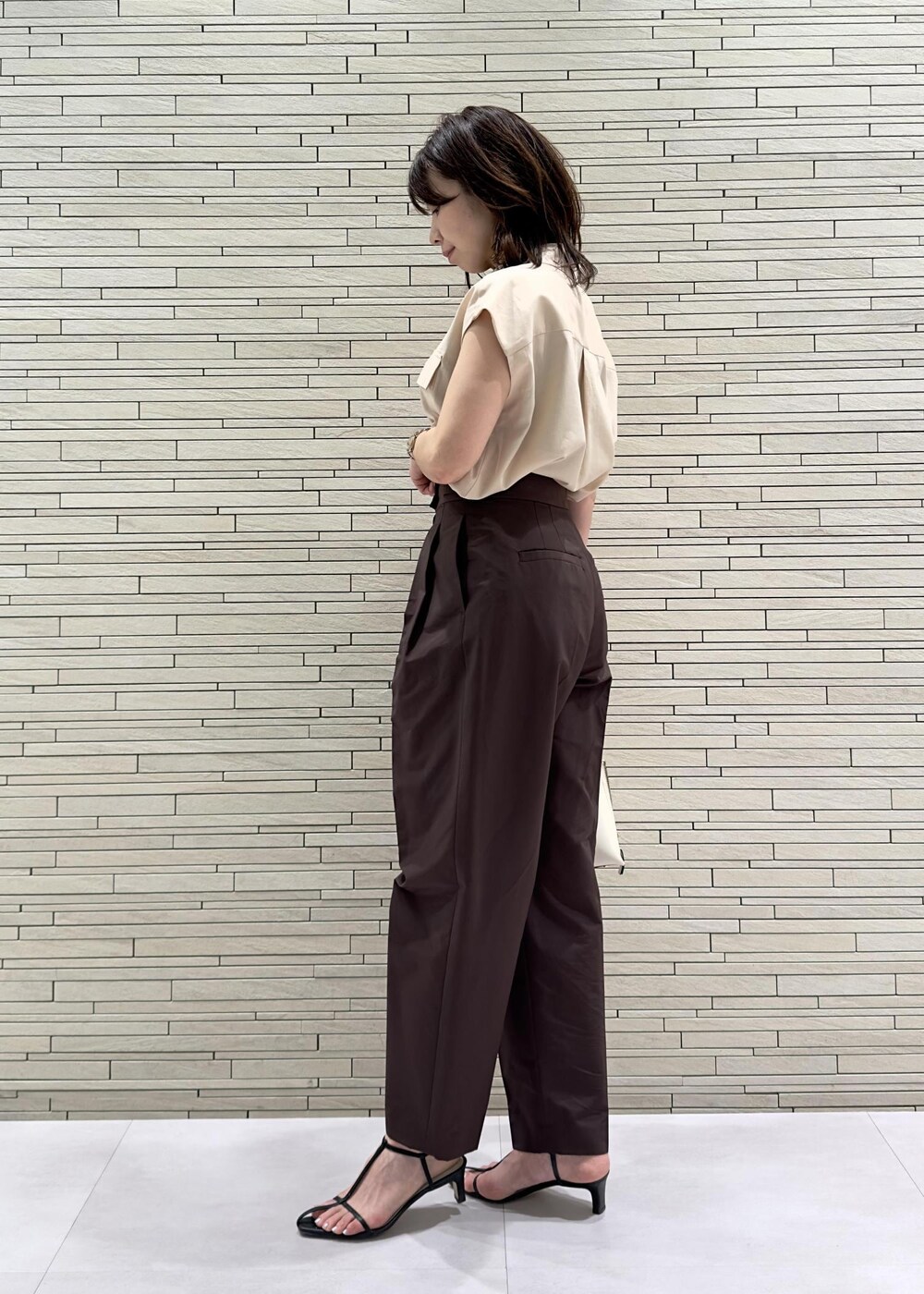 ブラック系のサンダル、ホワイト系のハンドバッグ、レッド系のその他パンツを着用したレディースの夏コーディネートの3枚目の写真