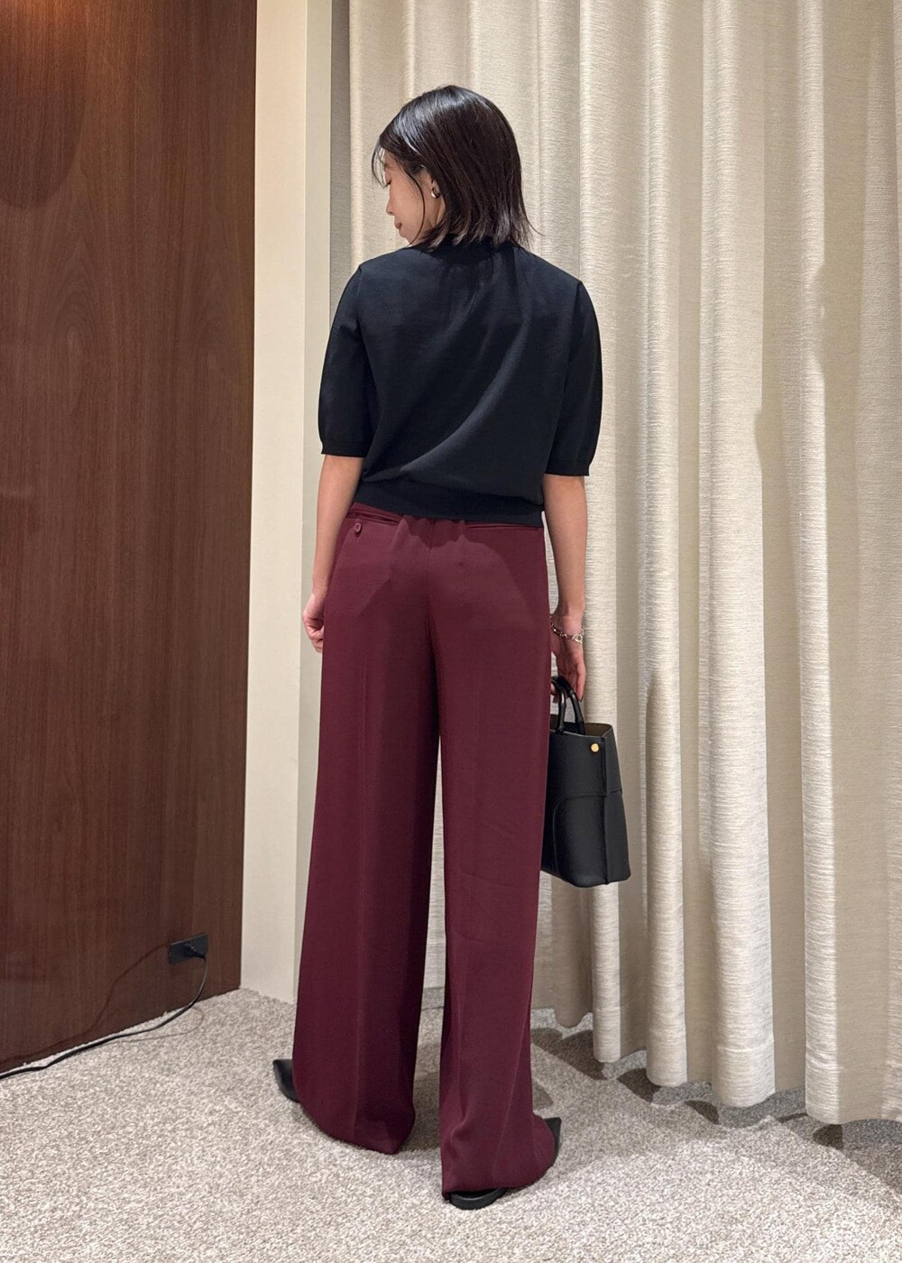 ブラック系のパンプス、レッド系のその他パンツ、ブラック系のハンドバッグを着用したレディースの夏コーディネートの3枚目の写真
