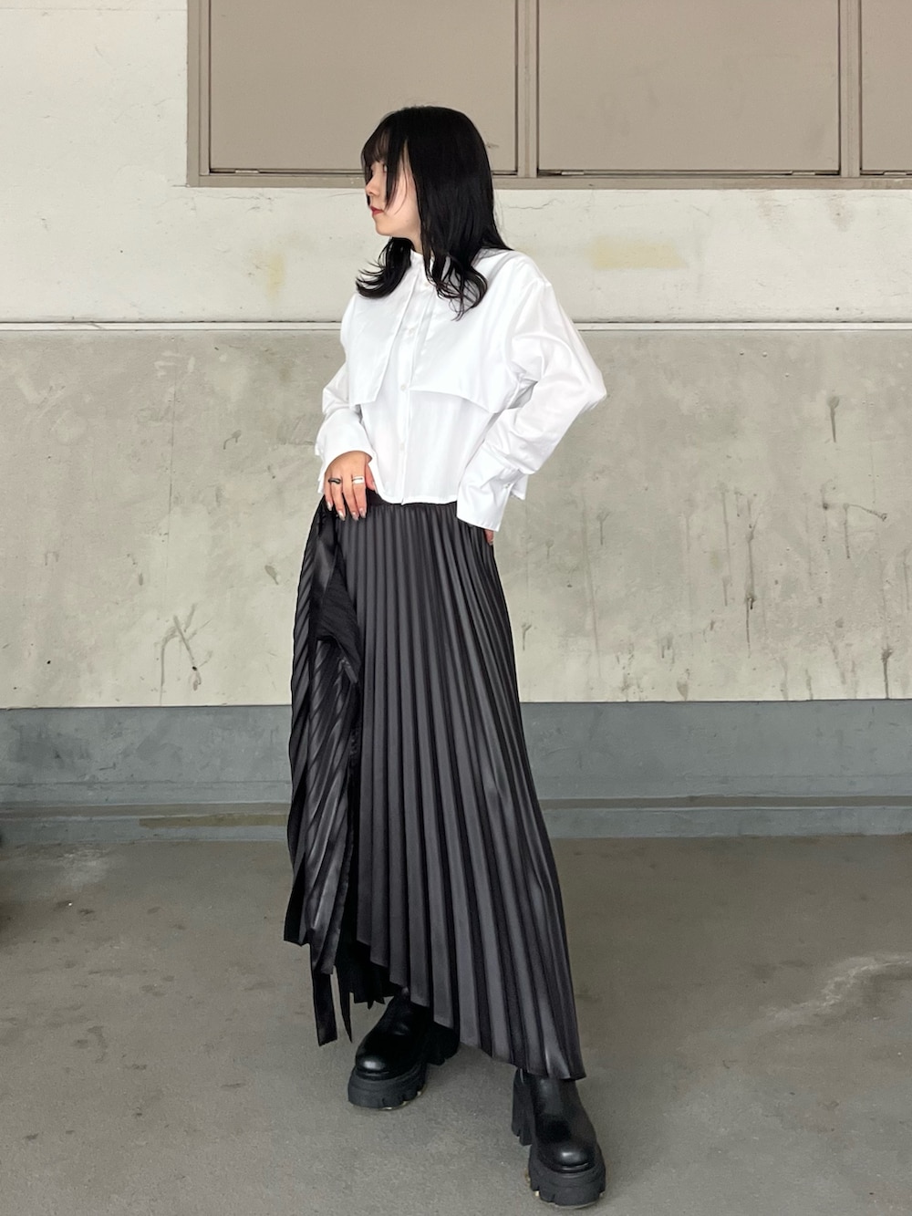 ホワイト系のシャツ/ブラウス、ブラック系のスカート、ブラック系のブーツを着用したレディースの秋コーディネートの3枚目の写真