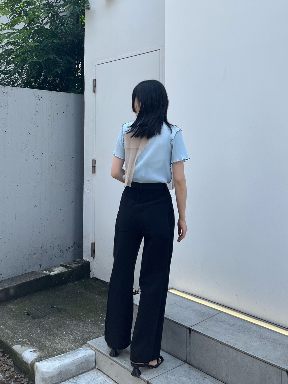 ブルー系のTシャツ/カットソー、ブラック系のスラックスを着用したレディースの夏コーディネートの3枚目の写真