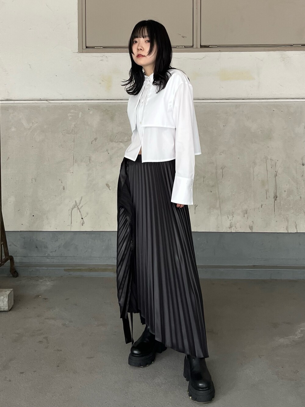ホワイト系のシャツ/ブラウス、ブラック系のスカート、ブラック系のブーツを着用したレディースの秋コーディネートの2枚目の写真