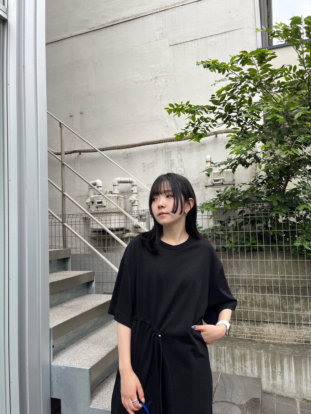 ブラック系のスラックスを着用したレディースの夏コーディネートの5枚目の写真