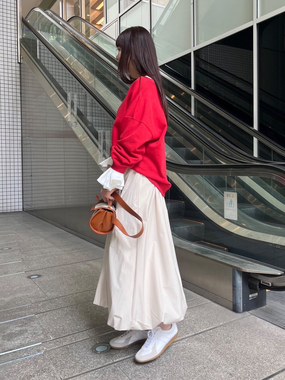 レッド系のスウェット、ホワイト系のTシャツ/カットソー、ホワイト系のスニーカーを着用したレディースの春コーディネートの2枚目の写真