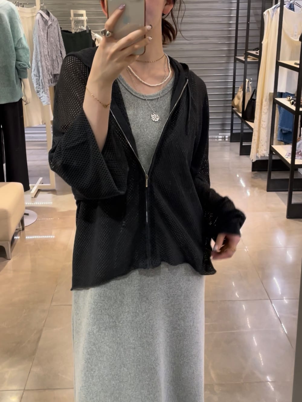 ブラック系のワンピース、グレー系のニット/セーターを着用したレディースの春コーディネートの2枚目の写真