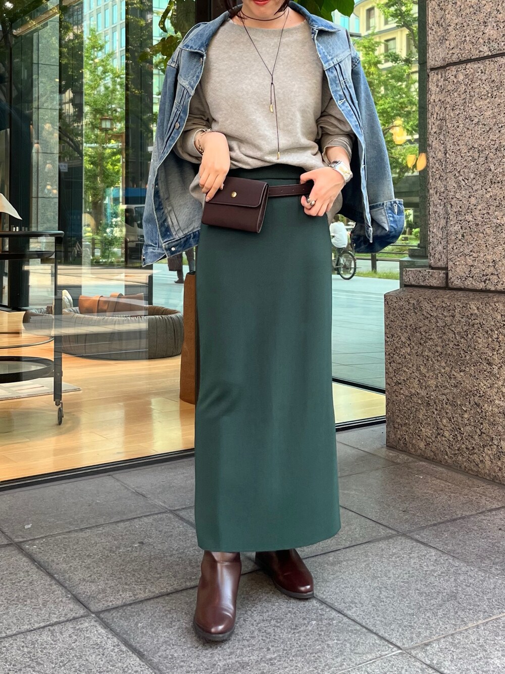 ブルー系のその他アウター、ブラウン系のショルダーバッグ、グリーン系のスカートを着用したレディースの秋コーディネートの2枚目の写真