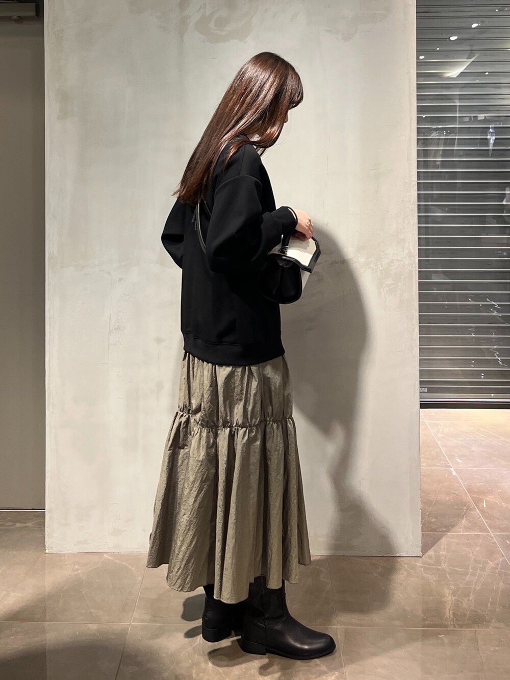 ブラック系のショルダーバッグ、ブルー系のシャツ/ブラウス、ブラック系のワンピースを着用したレディースの冬コーディネートの4枚目の写真