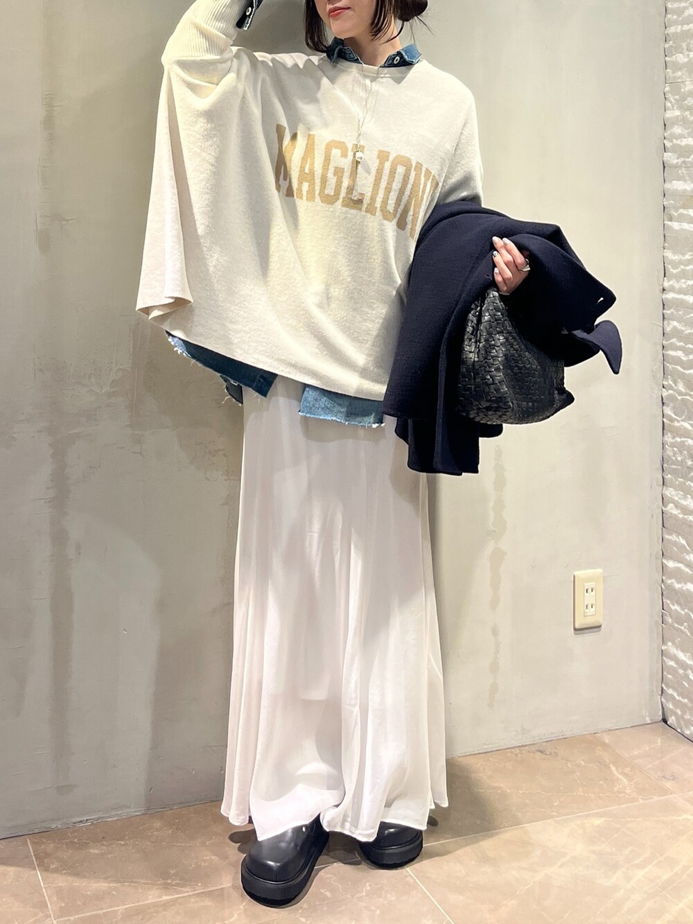 ホワイト系のスカート、ブルー系のシャツ/ブラウス、ホワイト系のニット/セーターを着用したレディースの冬コーディネートの4枚目の写真