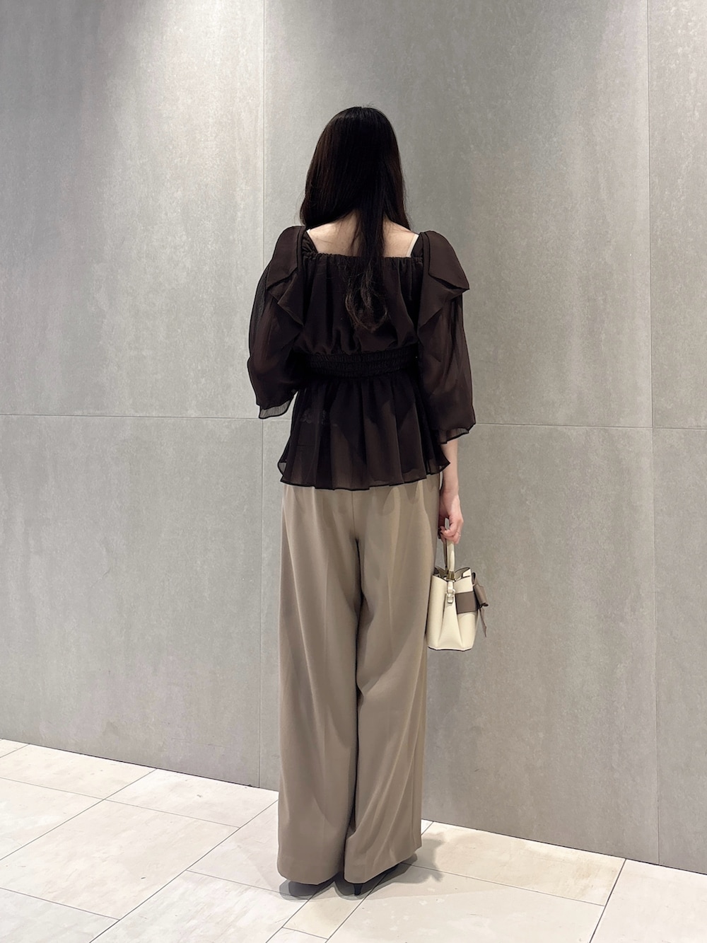ブラウン系のシャツ/ブラウス、ベージュ系のその他パンツ、ホワイト系のショルダーバッグを着用したレディースの秋コーディネートの4枚目の写真