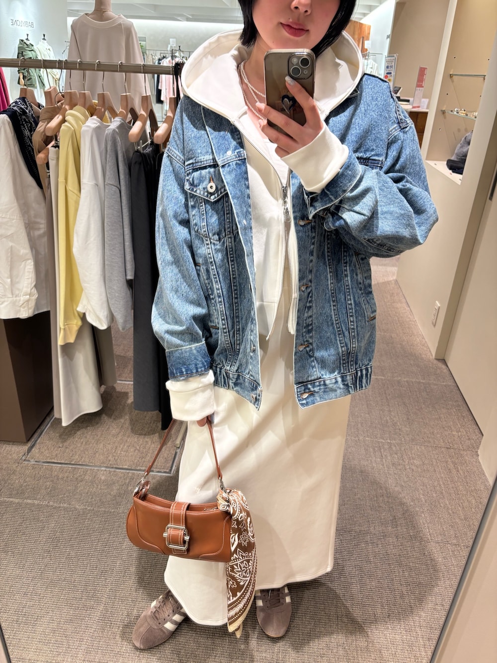 ホワイト系のパーカー、ホワイト系のニット/セーター、ホワイト系のスカートを着用したレディースの春コーディネートの3枚目の写真