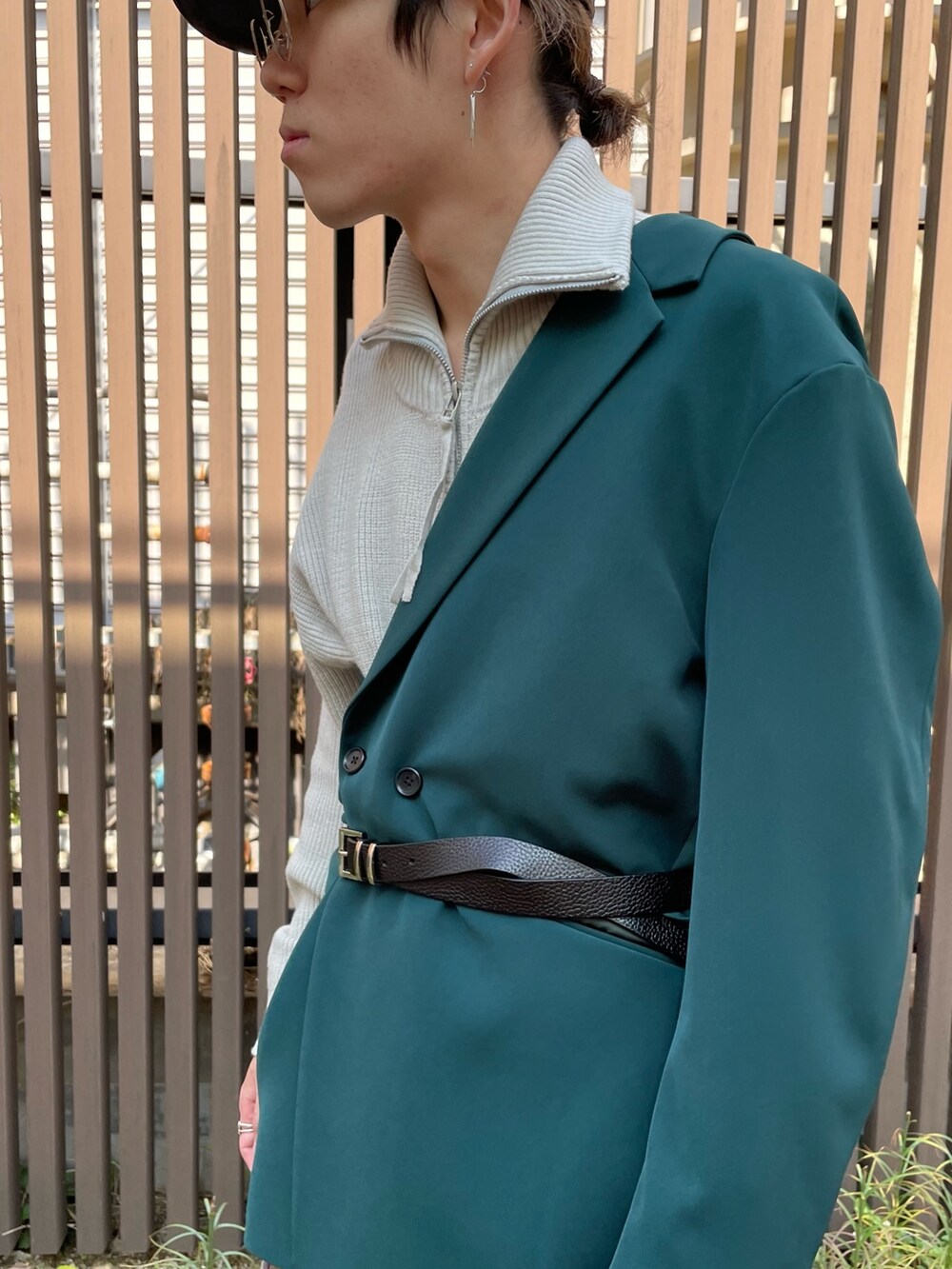 ブラック系のブーツ、ブルー系のデニムパンツ、グリーン系のテーラードジャケットを着用したメンズの秋コーディネートの2枚目の写真