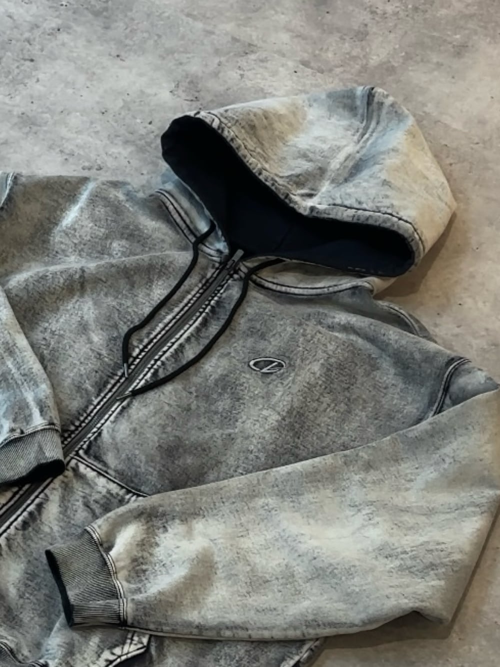 ブラック系のパーカー、ブラック系のマウンテンパーカー、ブラック系のデニムパンツを着用したメンズの冬コーディネートの4枚目の写真