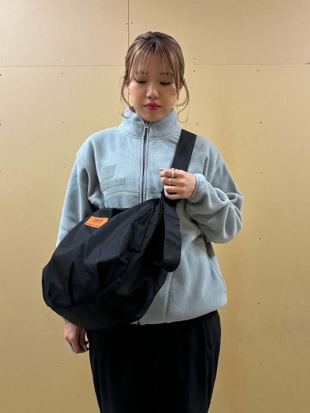 ブラック系のショルダーバッグ、ブルー系のブルゾンを着用したレディースの秋コーディネートの5枚目の写真