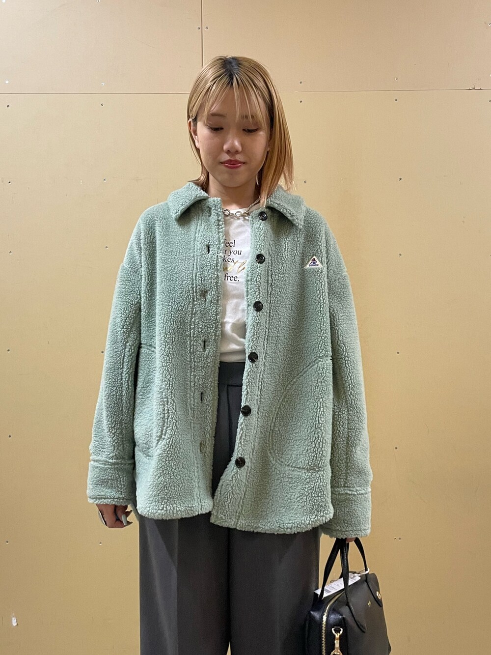 グレー系のその他パンツ、グリーン系のシャツ/ブラウス、ホワイト系のTシャツ/カットソーを着用したレディースの秋コーディネートの4枚目の写真